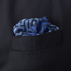 View 4 of product The Blue Maze Silk Pocket Square by Turnbull & Asser features a geometric maze-inspired pattern and central logo, with a folded corner for an artful touch.