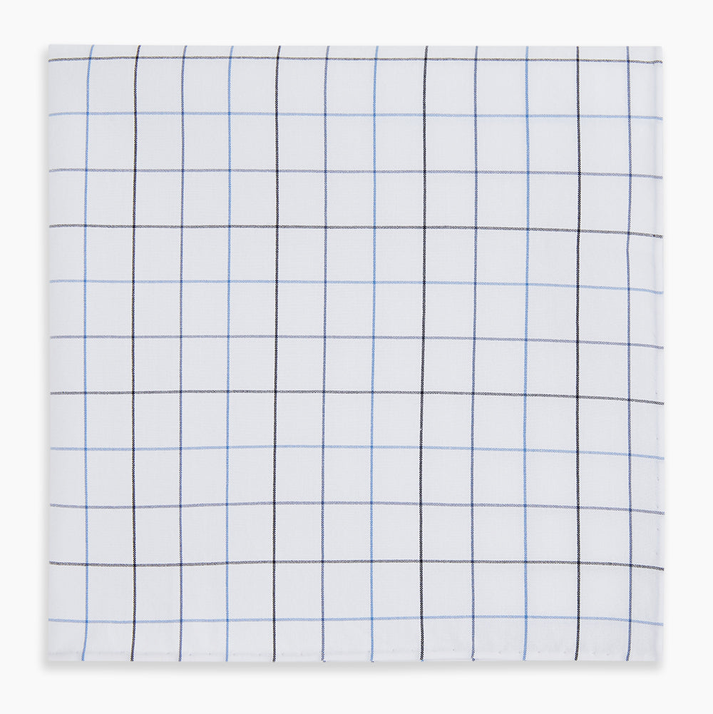 The Turnbull & Asser Hand Rolled Blue Grid Check Handkerchief features a classic blue and black grid on white cotton, neatly folded—a timeless gentleman's accessory.
