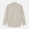 View 1 of product The Turnbull & Asser Light Oatmeal Linen Weekend Fit Unwin Shirt features long sleeves, a band collar, and two chest pockets—an ideal choice for effortless summer style.