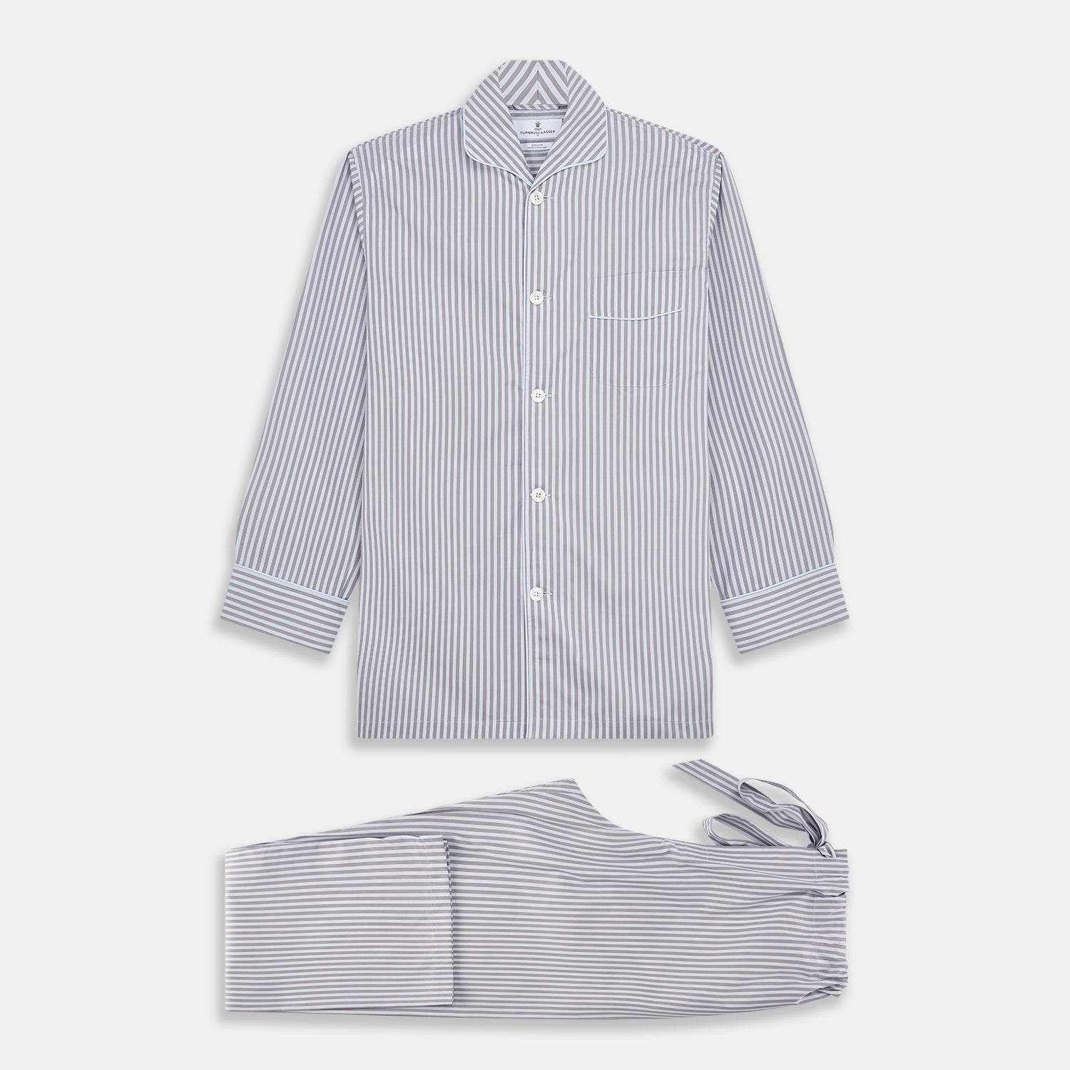View 1 of product The Turnbull & Asser Pale Blue Multi Stripe Cotton Quin Pyjamas, featuring a long-sleeve button-up top and matching adjustable tie-waist pants, are neatly arranged on a white background.