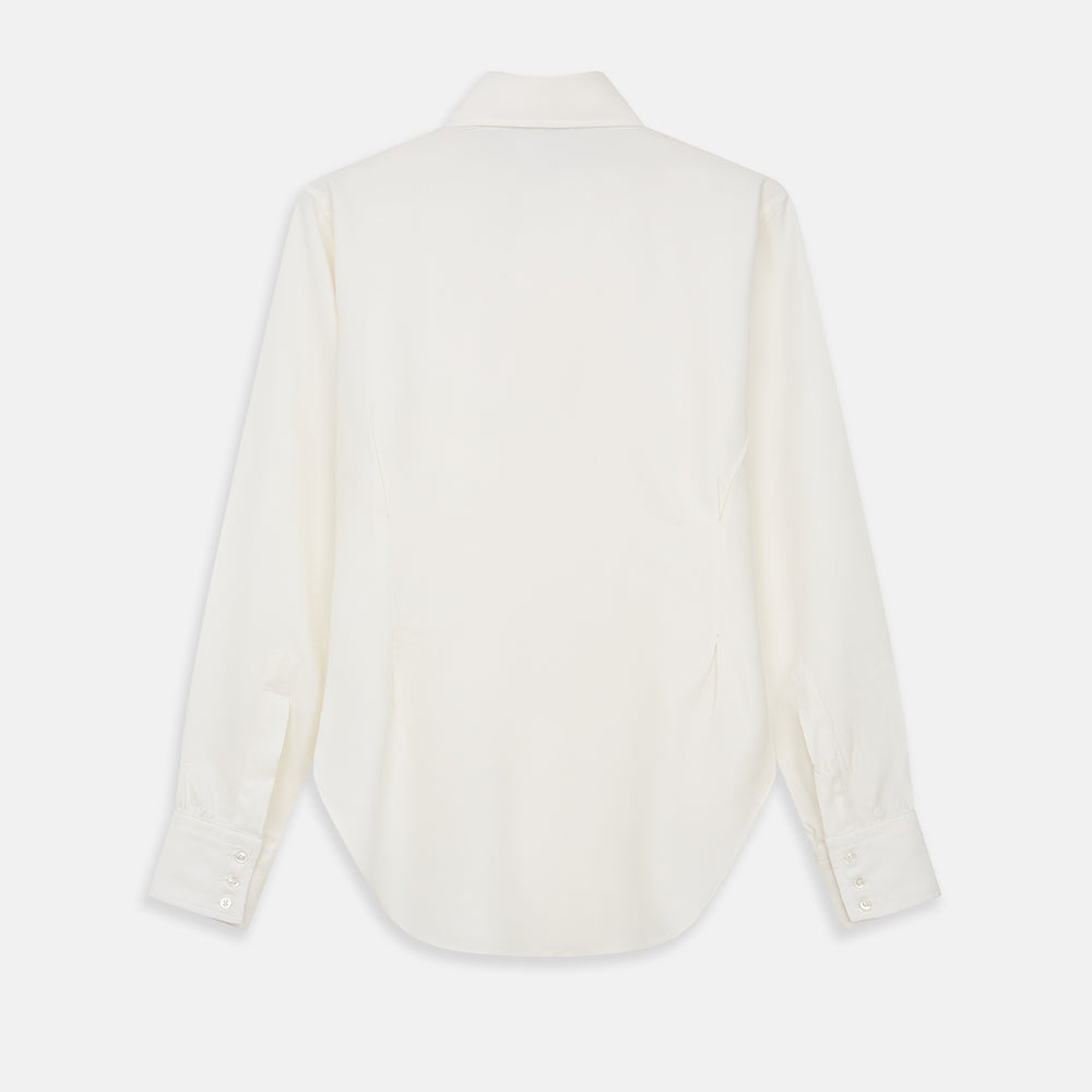 The Cream Silk Tailored Bianca Shirt by Turnbull & Asser features long sleeves, a pointed collar, and curved hem in soft-touch peace silk with a tailored fit. Shown laid flat on a white background.