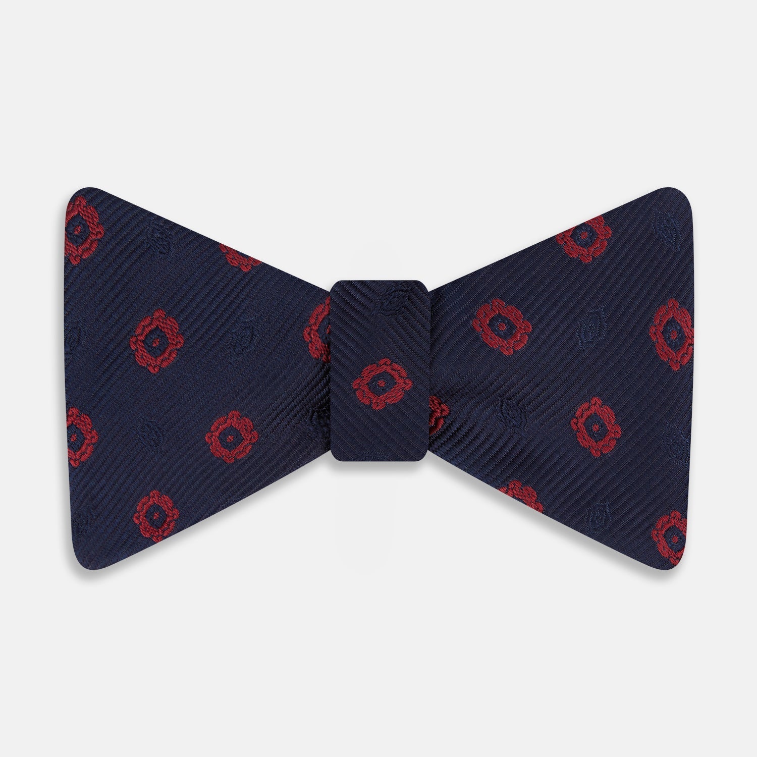 View 1 of product Elevate your formalwear with the Turnbull & Asser Navy and Burgundy Motif Silk Bow Tie, featuring a subtle ribbed texture and repeating red geometric motifs.