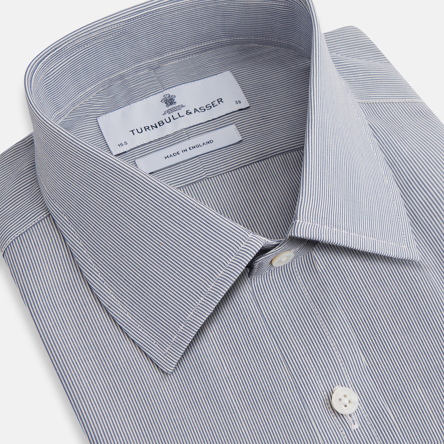 View 5 of product The Blue Fine Stripe Mayfair Shirt by Turnbull & Asser is a long-sleeve button-up with a sharp T&A collar and blue fine stripes, shown flat on a white background.