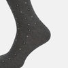 View 4 of product The Grey Patterned Mid-Length Socks by Turnbull & Asser are crafted from soft Egyptian cotton, with a ribbed cuff and small white diamond shapes on a grey background.