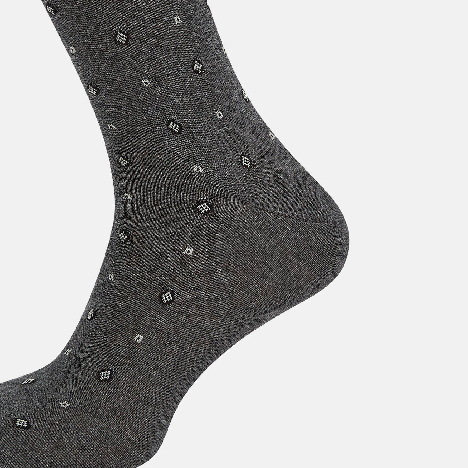 View 4 of product The Grey Patterned Mid-Length Socks by Turnbull & Asser are crafted from soft Egyptian cotton, with a ribbed cuff and small white diamond shapes on a grey background.