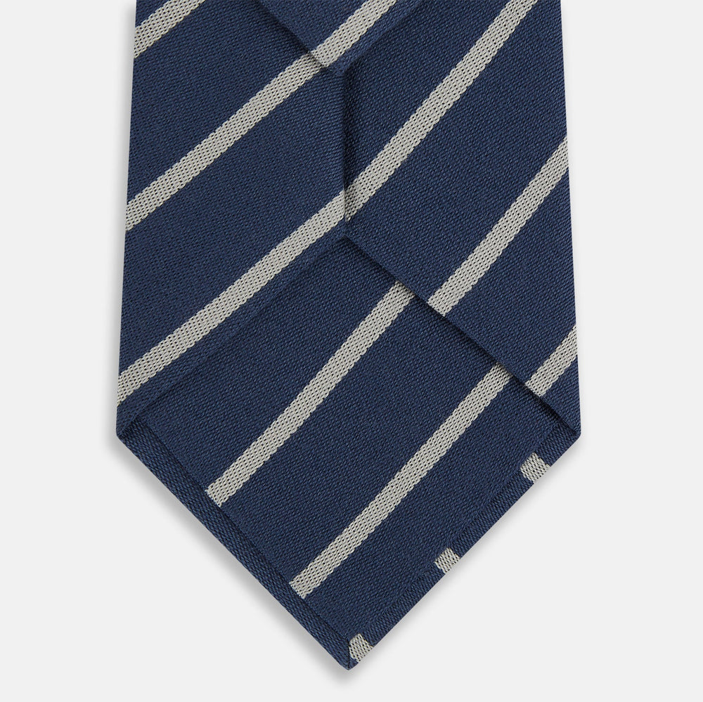 The Turnbull & Asser Navy Block Stripe Silk Blend Tie features navy and cream stripes with diagonal light gray accents, displayed against a plain white background.