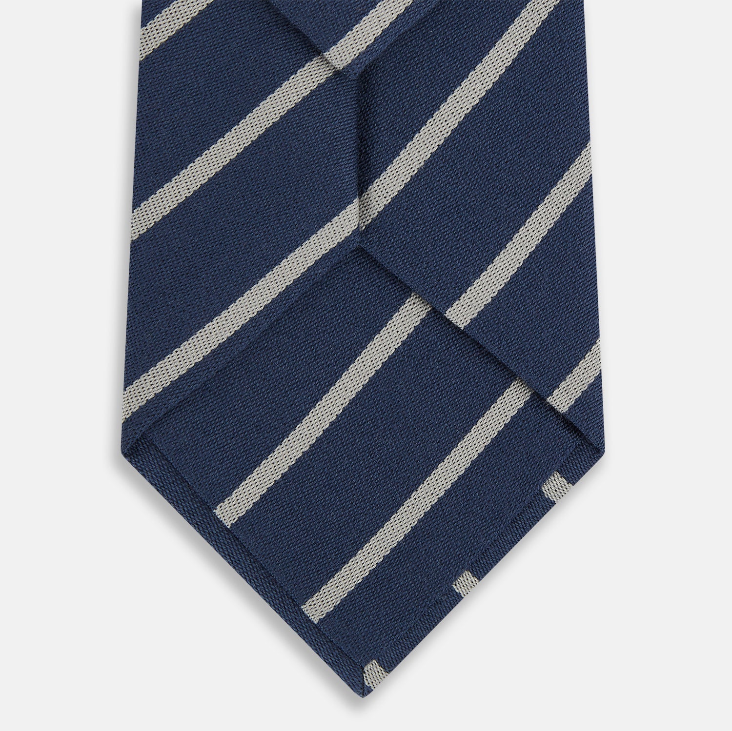 View 3 of product The Turnbull & Asser Navy Block Stripe Silk Blend Tie features navy and cream stripes with diagonal light gray accents, displayed against a plain white background.