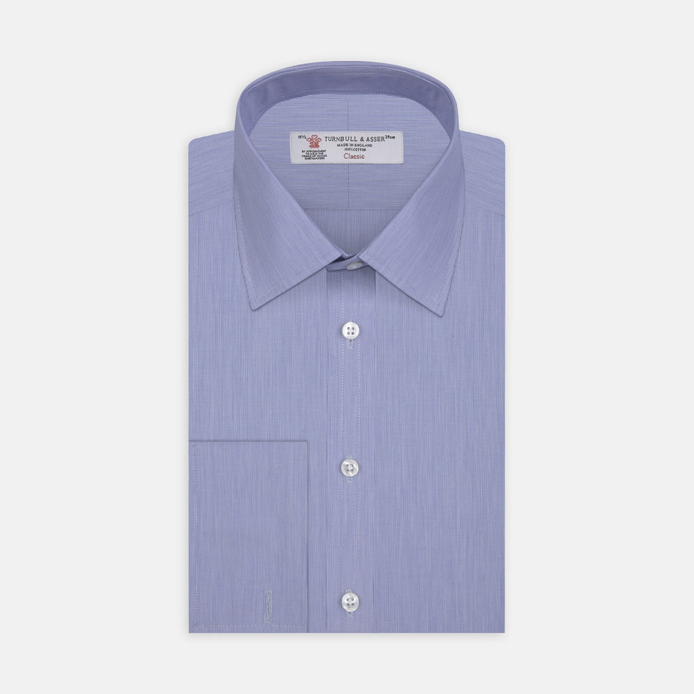 The Turnbull & Asser Blue Hairline Stripe Shirt features a T&A collar, 3-button cuffs, and white buttons. Made from light blue cotton with subtle stripes, it’s neatly folded with the label visible inside the collar on a plain white background.
