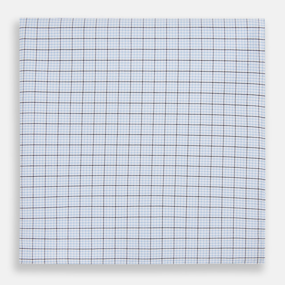 The Hand Rolled Blue Multi Graph Check Handkerchief by Turnbull & Asser features a white base with a blue grid and bold lines, resembling elegant graph paper, set against a clean white background.