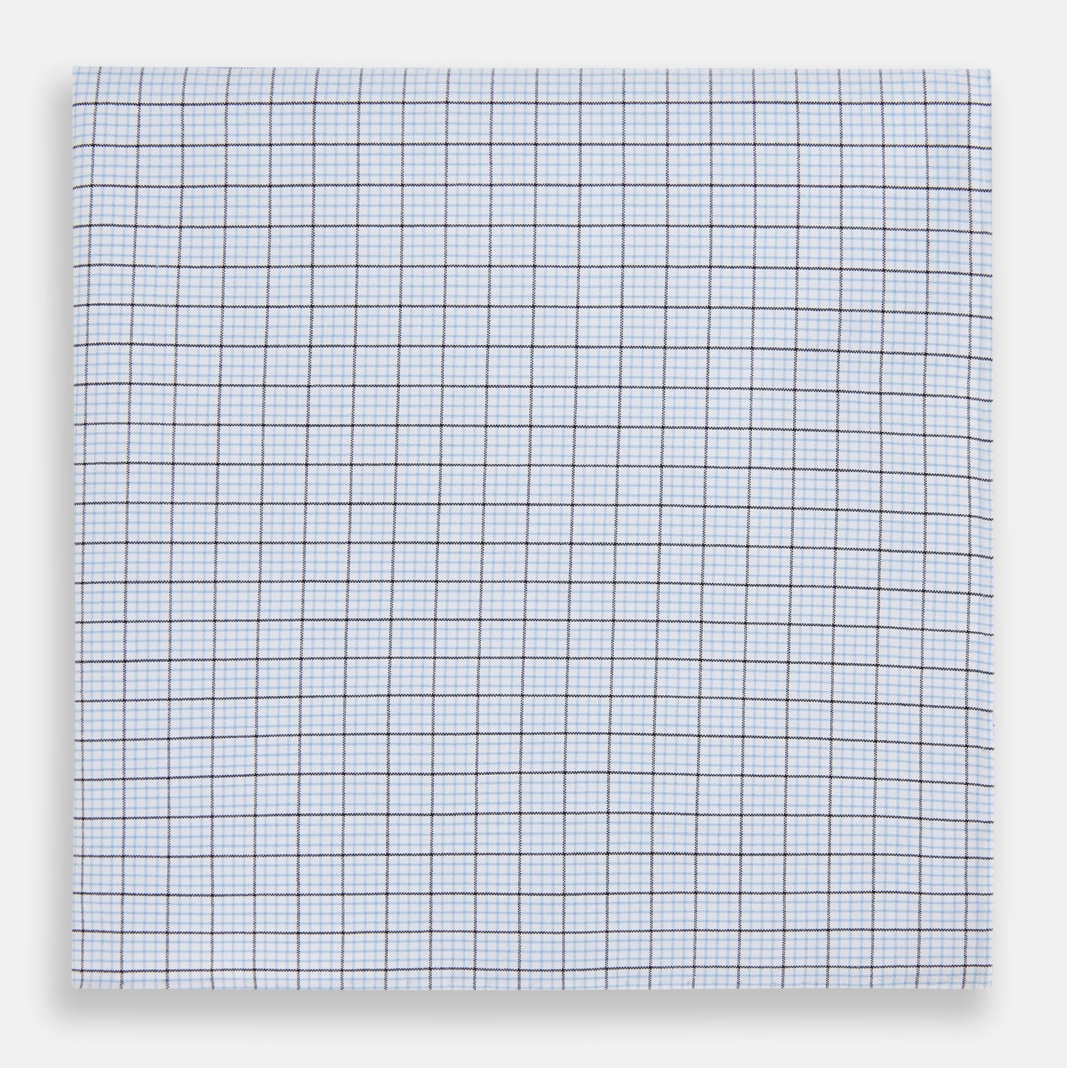 View 1 of product The Hand Rolled Blue Multi Graph Check Handkerchief by Turnbull & Asser features a white base with a blue grid and bold lines, resembling elegant graph paper, set against a clean white background.
