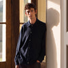 View 5 of product The Turnbull & Asser Navy Cashmere Duncan Knitted Shirt, a button-up with collar, long sleeves, chest pocket, and straight hem, is shown laid flat on a white background.