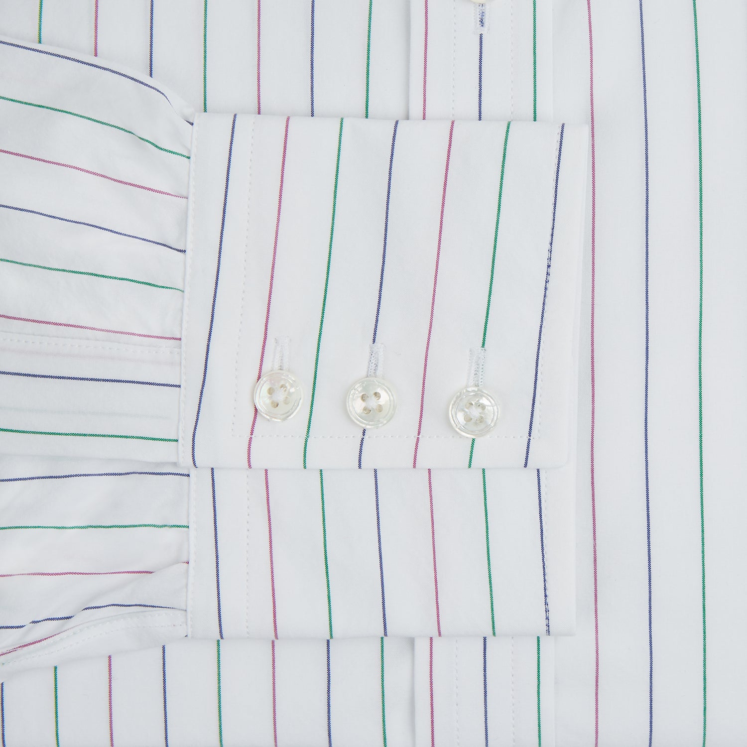 View 4 of product The Turnbull & Asser Pink and Green Wide Pinstripe Mayfair Shirt is a long-sleeve, button-up shirt made from organic cotton, shown laid flat on a white background.