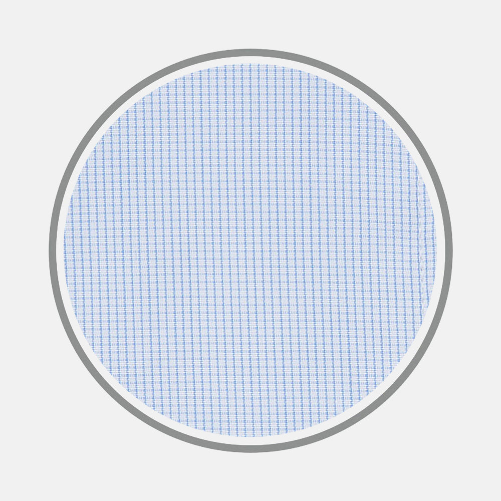 A circular swatch of Turnbull & Asser’s Light Blue Fine Check Cotton Fabric, featuring a fine vertical white grid on light blue, is bordered by a thin gray outline and shown against a plain white background.