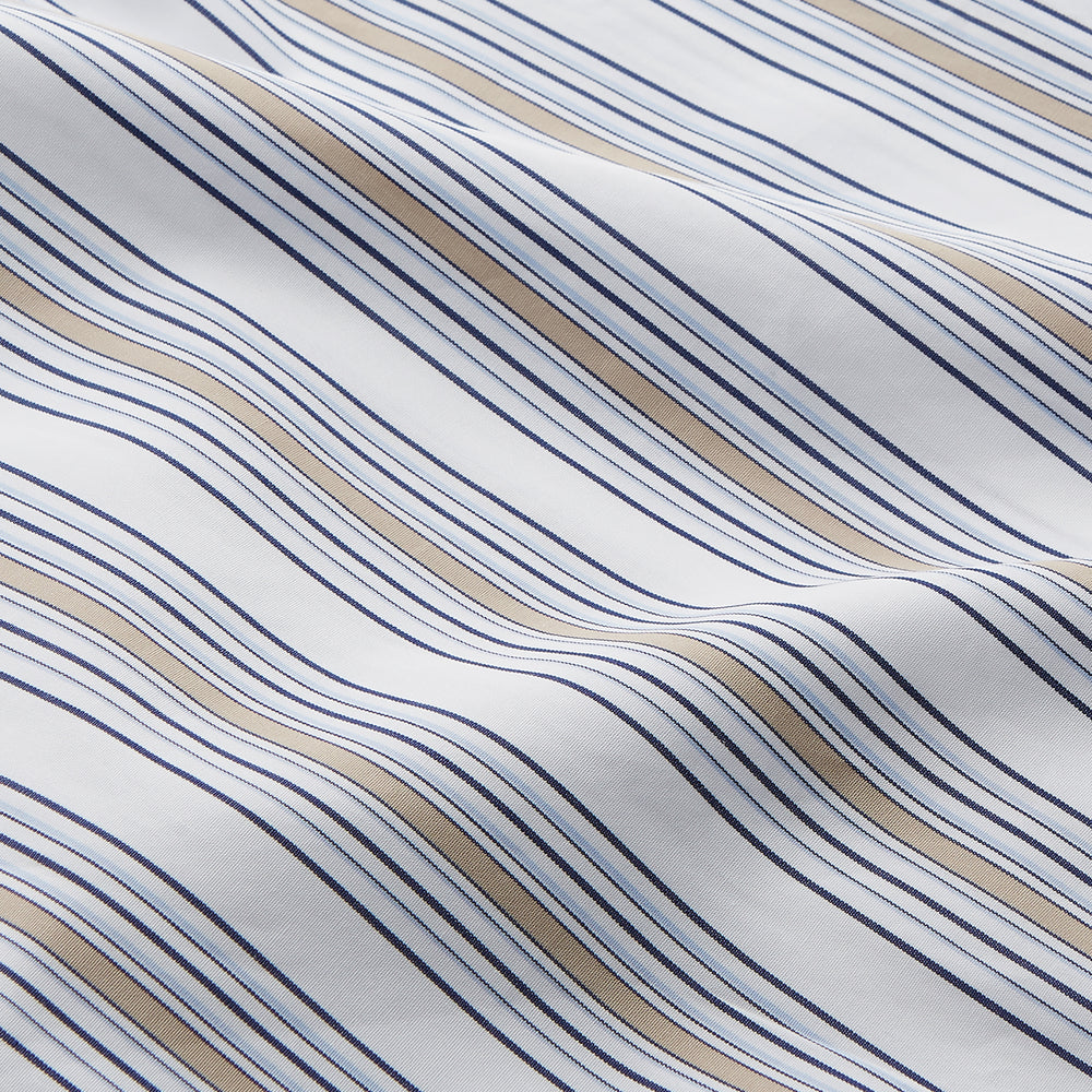 The Turnbull & Asser Sand Multi Stripe Regular Fit Shirt features a T&A collar, 3 button cuffs, and vertical blue, white, and light brown stripes. The shirt is shown neatly laid flat on a white background.