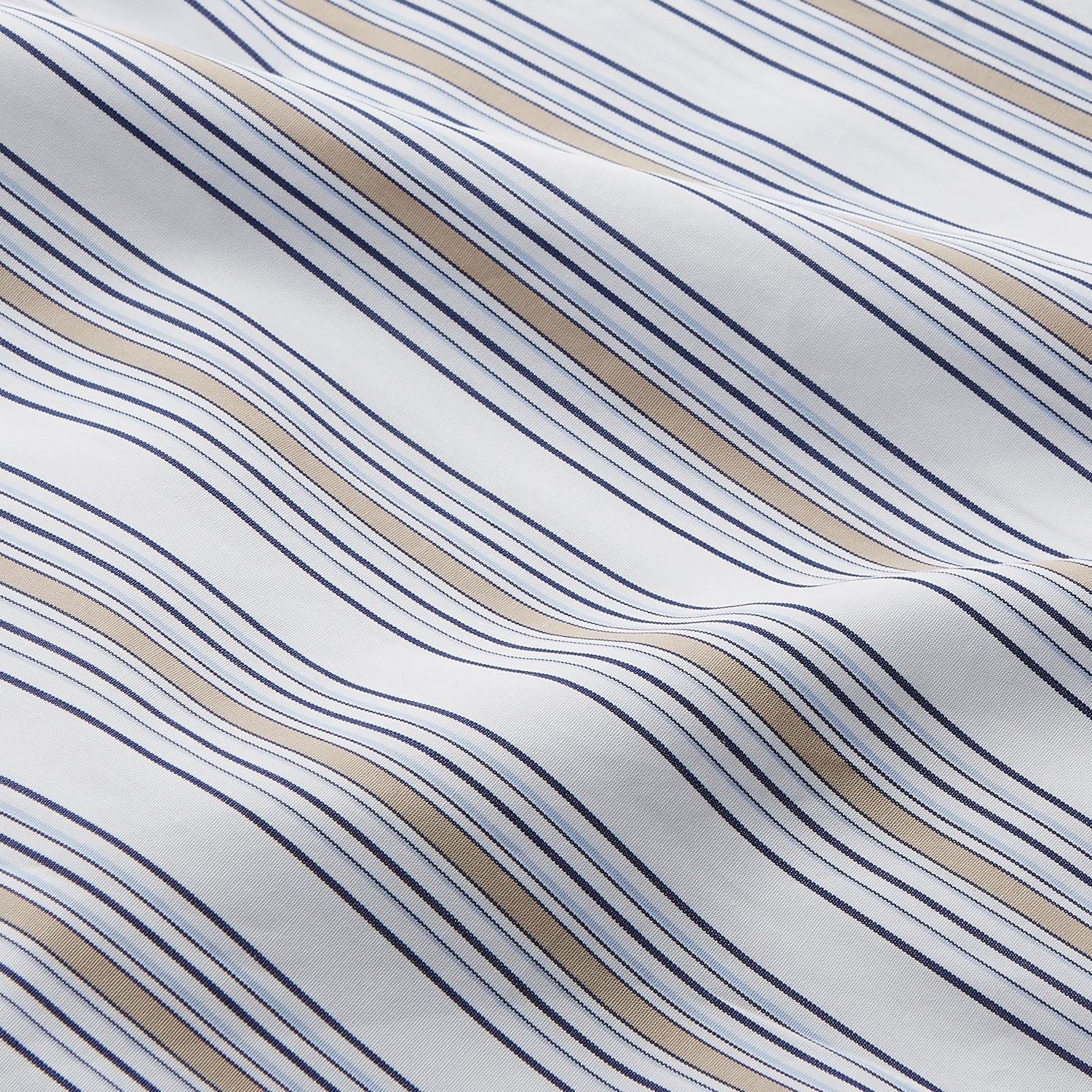 View 4 of product The Turnbull & Asser Sand Multi Stripe Regular Fit Shirt features a T&A collar, 3 button cuffs, and vertical blue, white, and light brown stripes. The shirt is shown neatly laid flat on a white background.