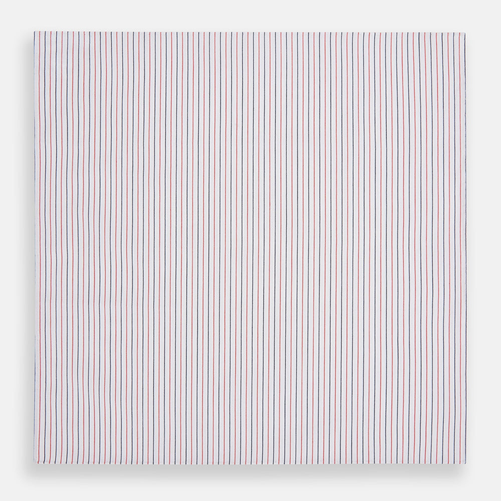 The Turnbull & Asser Hand Rolled Red and Navy Pinstripe Handkerchief features evenly spaced vertical stripes on white cotton, offering a clean, classic look as an elegant gentleman's accessory or stylish pocket square.