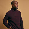 View 7 of product The Turnbull & Asser Burgundy Mullion Half Zip Rib Cashmere Jumper features a high collar and half-zip front in dark red and navy cashmere, shown laid flat on a white background—ideal for an elevated casual look.