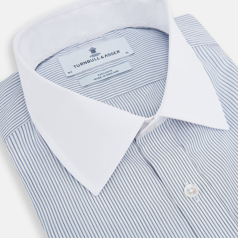 The Turnbull & Asser Navy and Blue Ticking Stripe Shirt features a contrast white collar and double cuffs, displayed on a plain white background. Tailored in the sleek Mayfair fit, it’s ideal for formal attire.