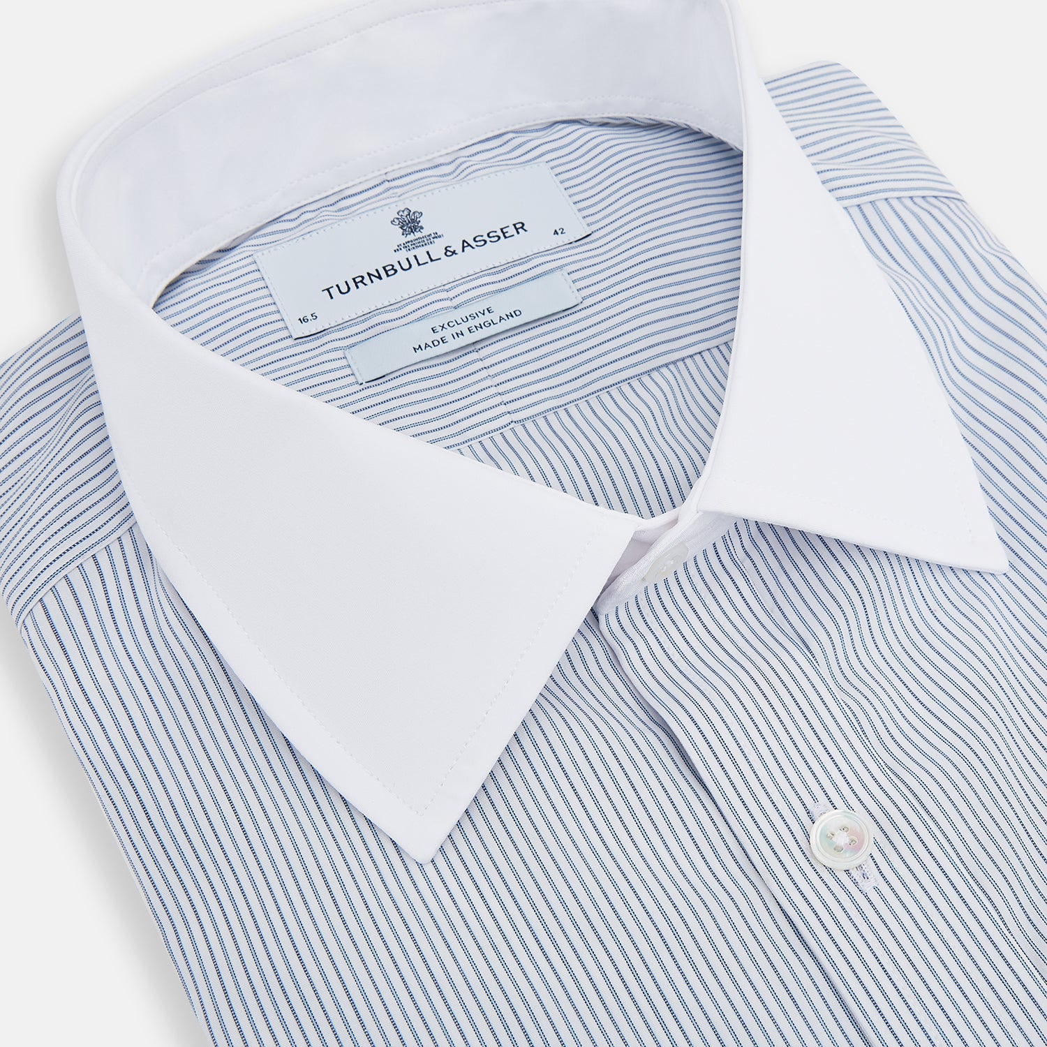 View 2 of product The Turnbull & Asser Navy and Blue Ticking Stripe Shirt features a contrast white collar and double cuffs, displayed on a plain white background. Tailored in the sleek Mayfair fit, it’s ideal for formal attire.