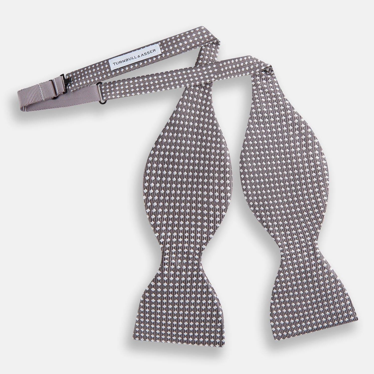 View 2 of product The Turnbull & Asser Grey and White Diamond Silk Bow Tie showcases a subtle diamond pattern, ideal for formalwear, and is elegantly displayed against a plain white background.