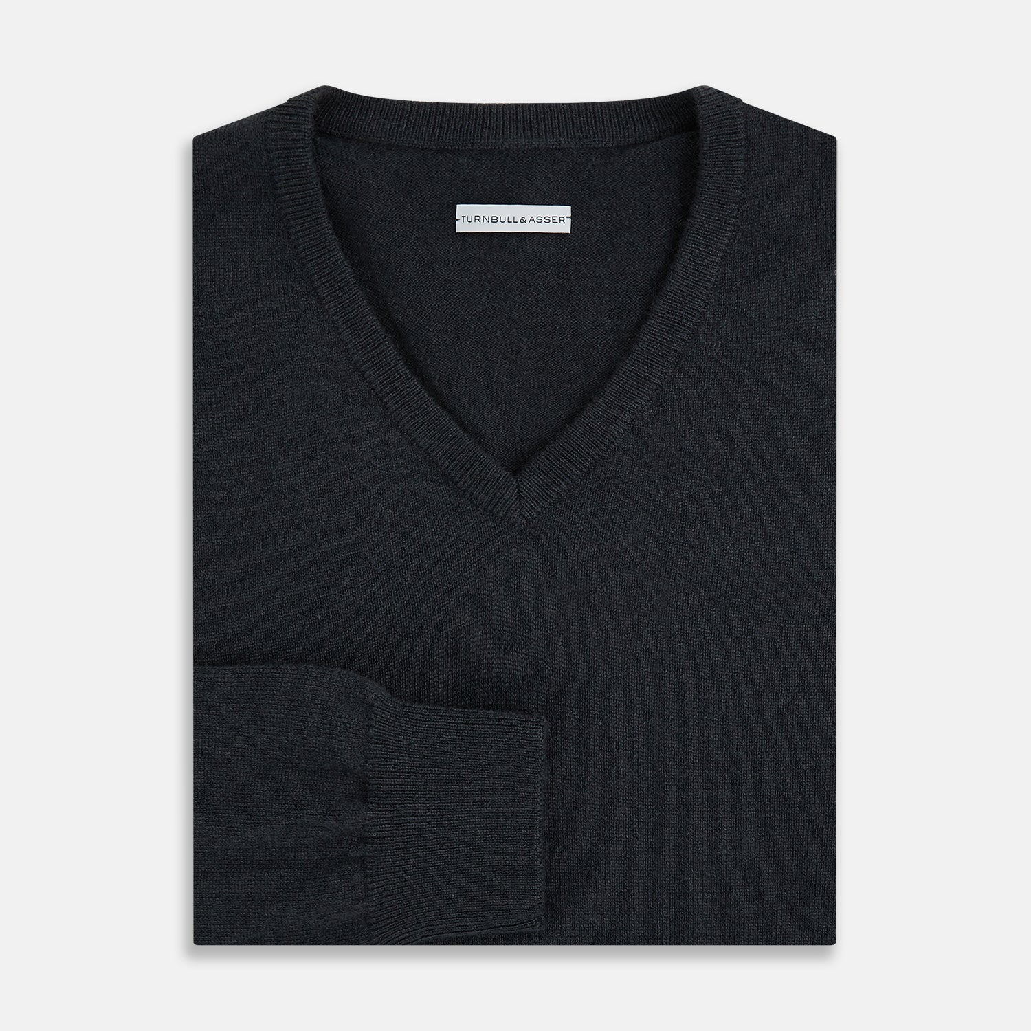 View 4 of product The Turnbull & Asser Dark Green Cashmere V-Neck Jumper features long sleeves, ribbed cuffs, and a ribbed waistband, showcased against a white background.