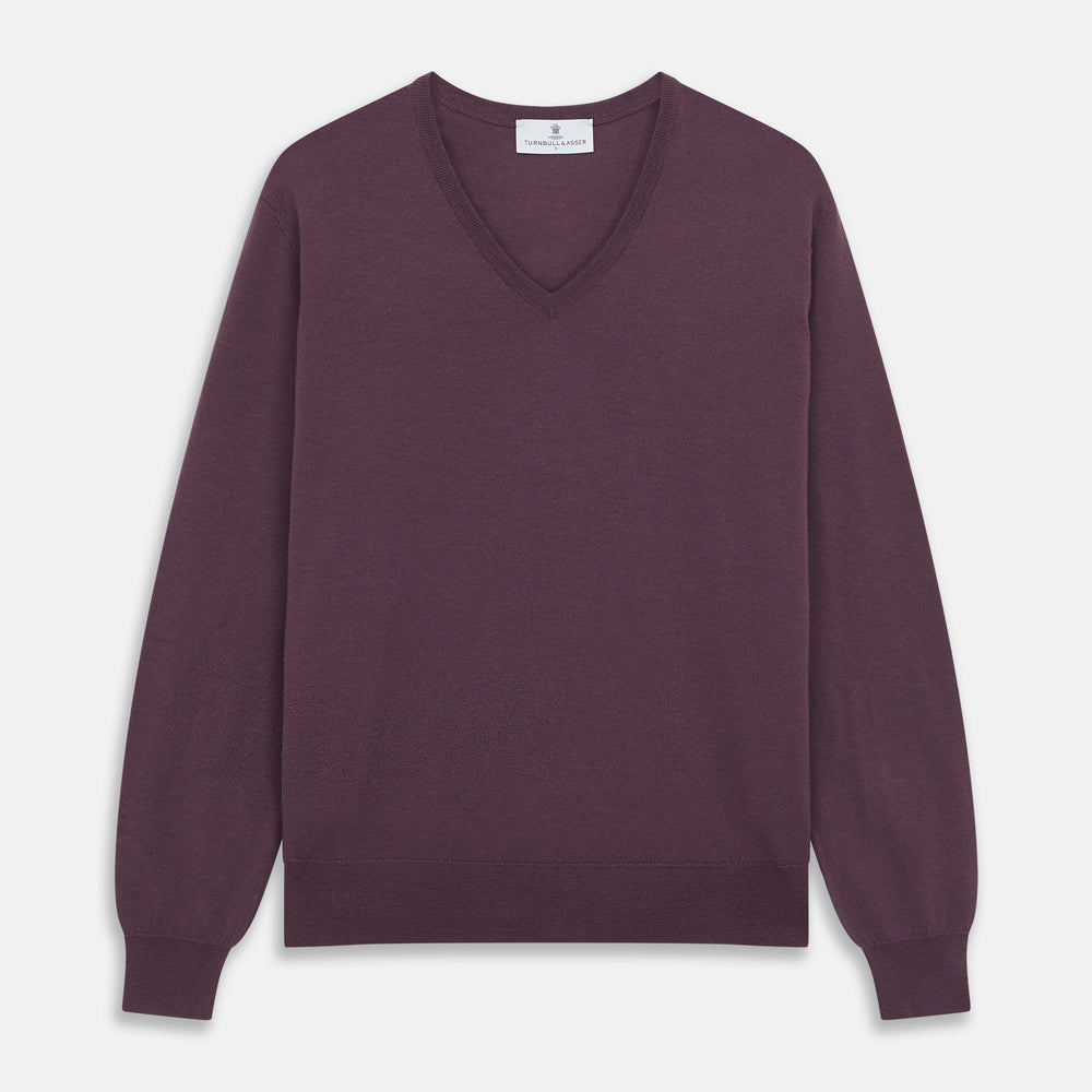 The Turnbull & Asser Plum Kennedy Merino V-Neck Jumper is a long-sleeved knitwear piece made from soft Italian wool, shown laid flat on a white background.