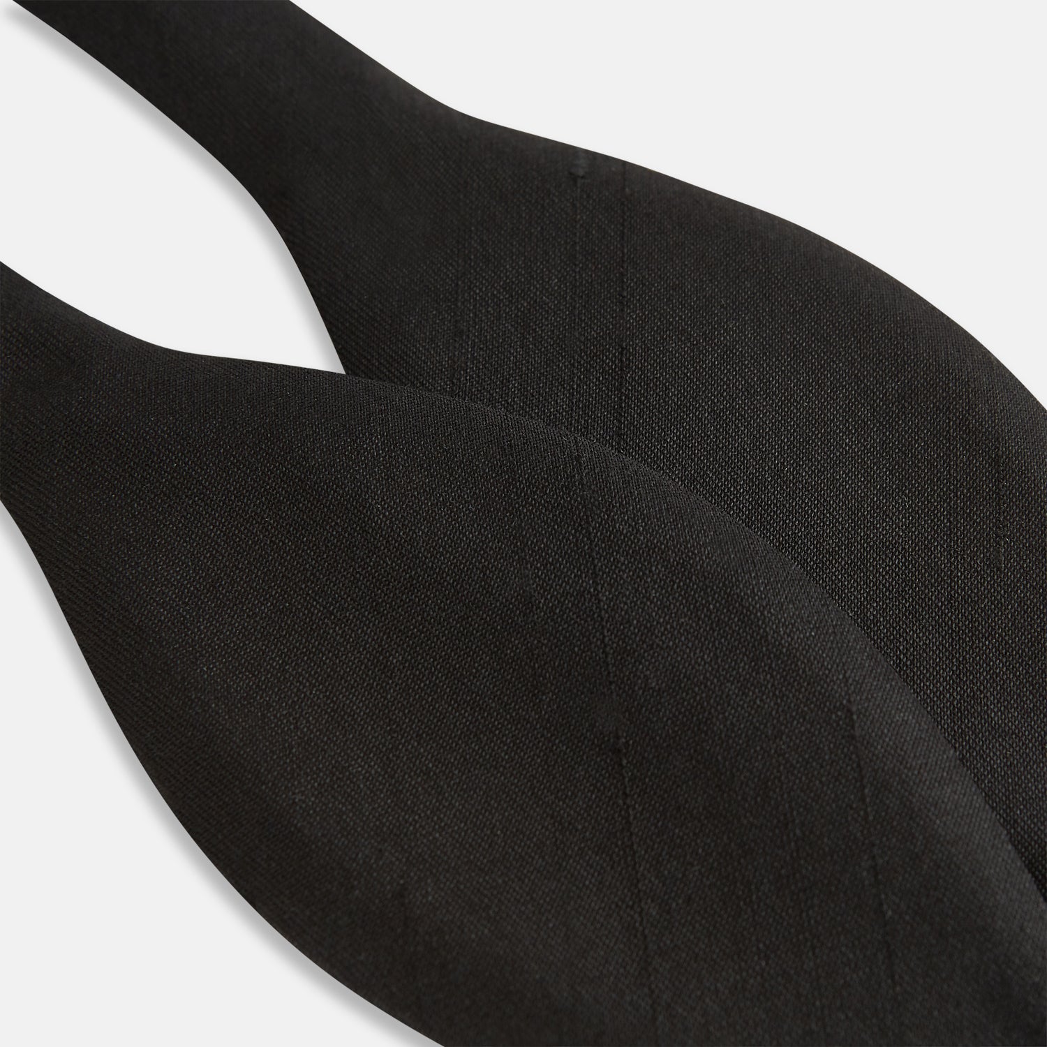 View 3 of product The Casino Royale Shantung Silk Bow Tie by Turnbull & Asser, as seen on James Bond, features a classic shape in black silk and is set against a plain white background—a timeless gentleman’s accessory.