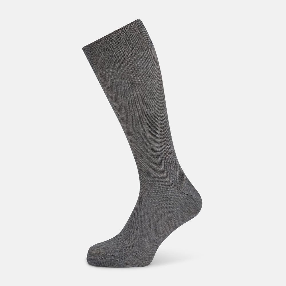 A single Steel Melange Micro Knit Mid-Length Sock by Turnbull & Asser, knee-high and gray, crafted from mercerised Egyptian cotton with a subtle micro knit pattern, is displayed upright on a plain white background.