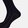 View 4 of product The Turnbull & Asser Azzurro/violet Dash Striped Long Sock, crafted from mercerised Egyptian cotton, features thin blue pinstripes on black and is shown upright against a plain white background.