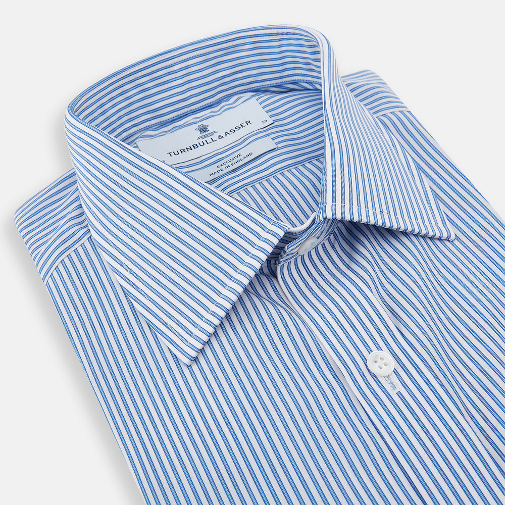 The Sky Blue Halo Stripe Mayfair Shirt by Turnbull & Asser, a long-sleeved button-up with thin blue and white vertical stripes, classic collar and cuffs, is shown laid flat on a white background.