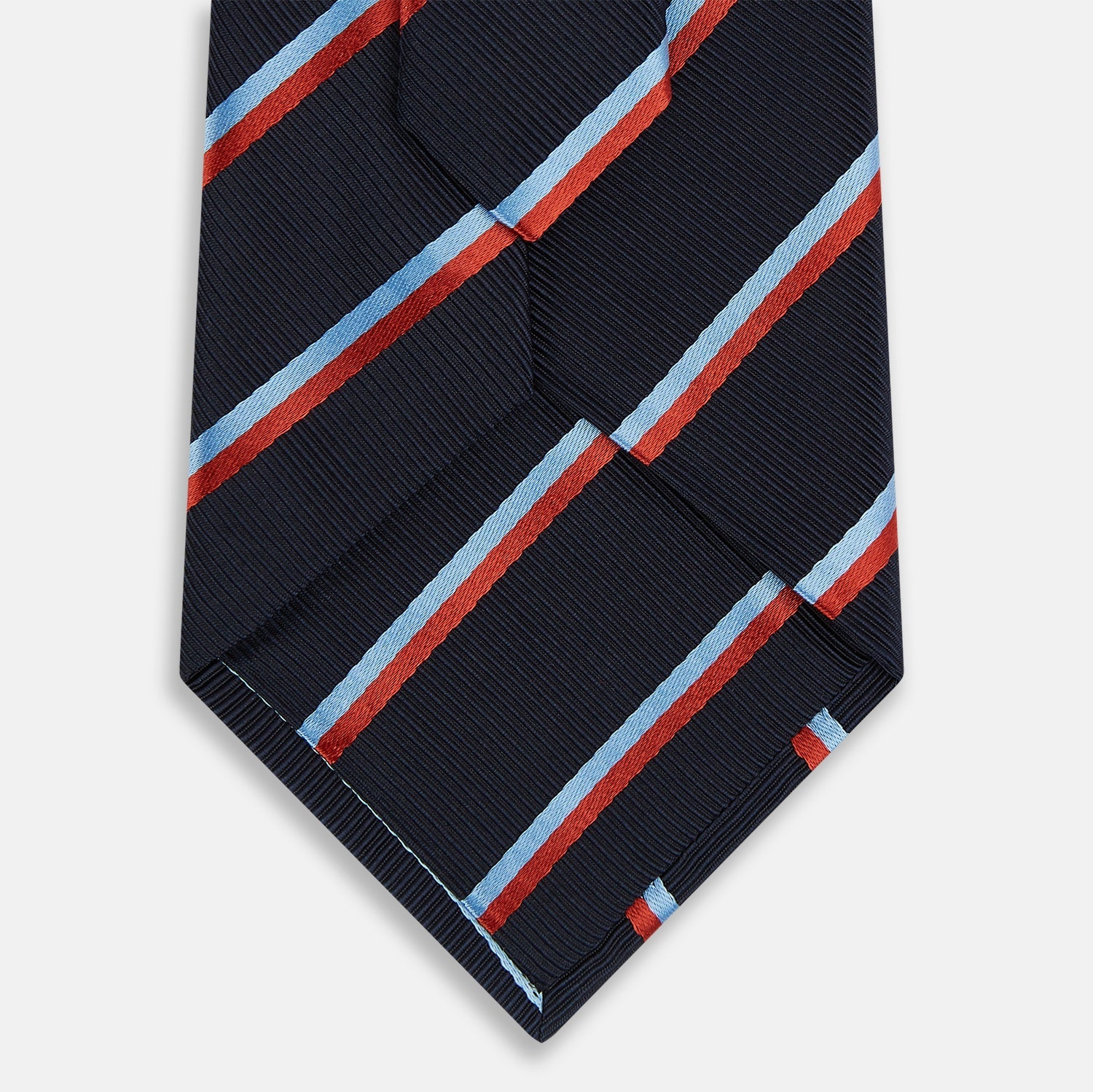 View 3 of product The Turnbull & Asser Red And Blue Stripe Silk Blend Tie, rolled on a white background, features refined diagonal accents—an elegant formal accessory.