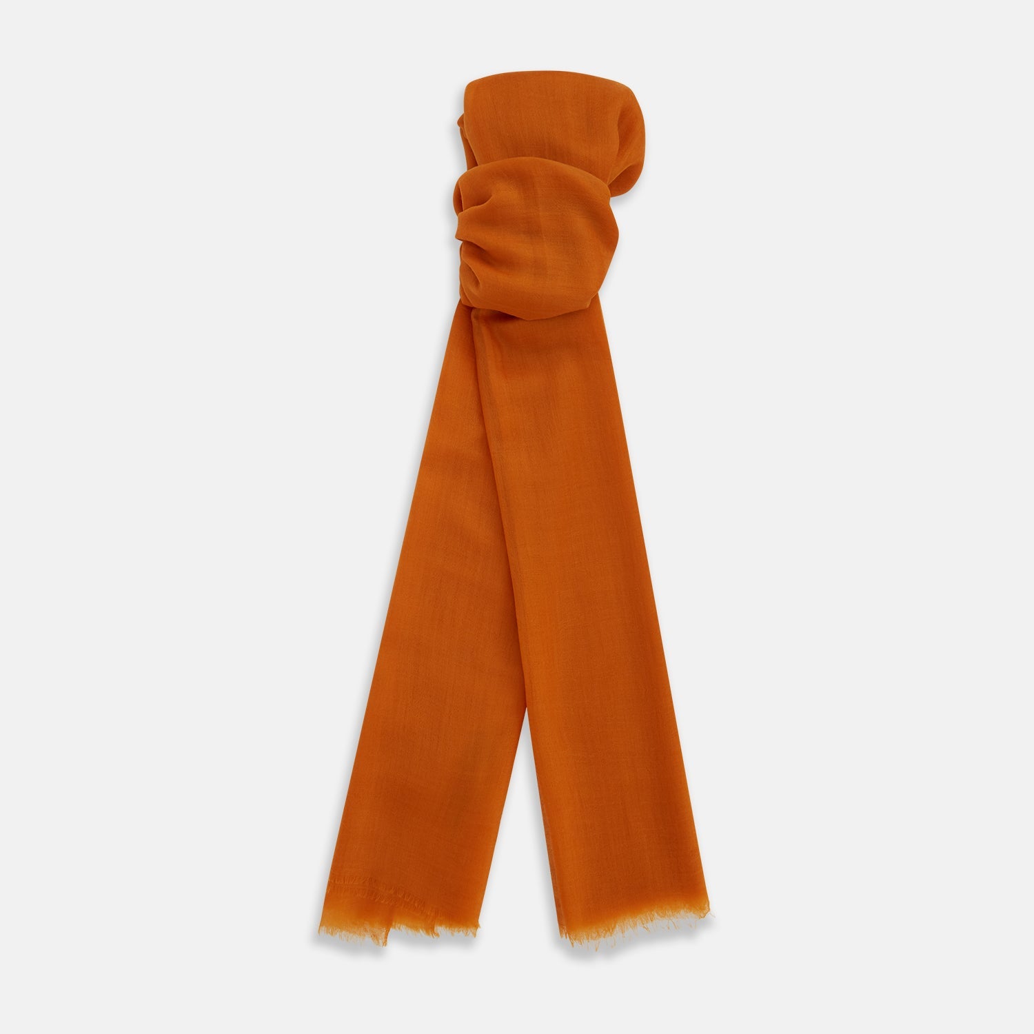 View 1 of product The Orange Cashmere Scarf by Turnbull & Asser features a soft texture, fringed edges, and a rich orange hue—an elegant luxury accessory displayed on a white background.
