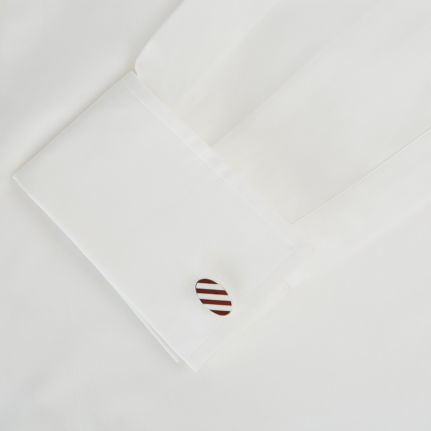 View 3 of product Turnbull & Asser's Burgundy and White Striped Oval Enamel Cufflinks feature a diagonal pattern in silver, embodying masculine elegance.