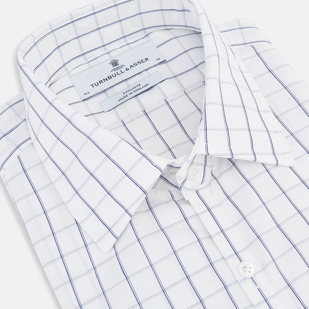 A Dark Navy Double-Line Checked Westminster Shirt by Turnbull & Asser, featuring button-down front, pointed collar, and buttoned cuffs—displaying British craftsmanship—laid flat on a white background.