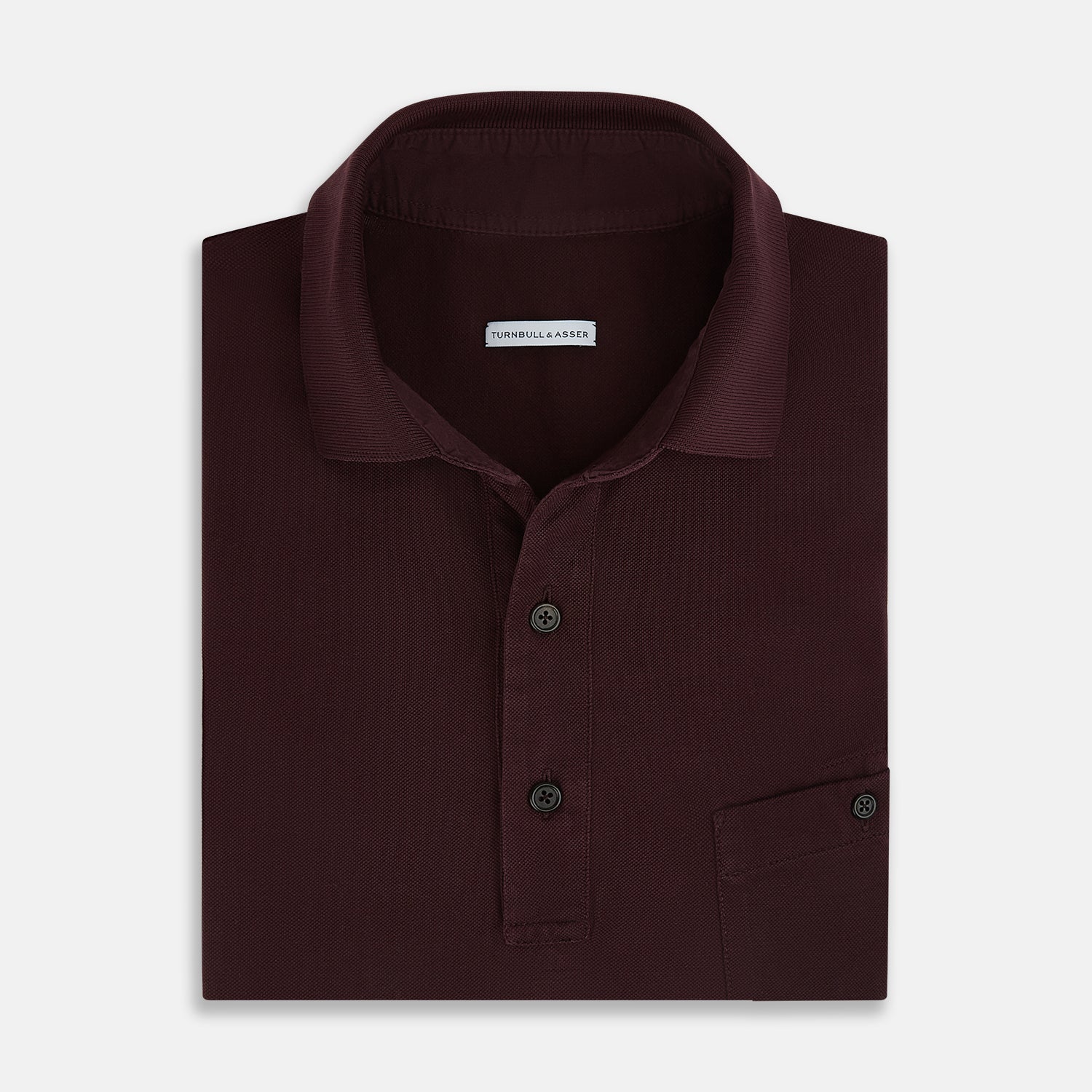 View 4 of product The Turnbull & Asser Burgundy Polo Shirt is crafted from soft cotton jersey with short sleeves, a classic collar, three front buttons, and a small buttoned chest pocket, shown flat on a white background.