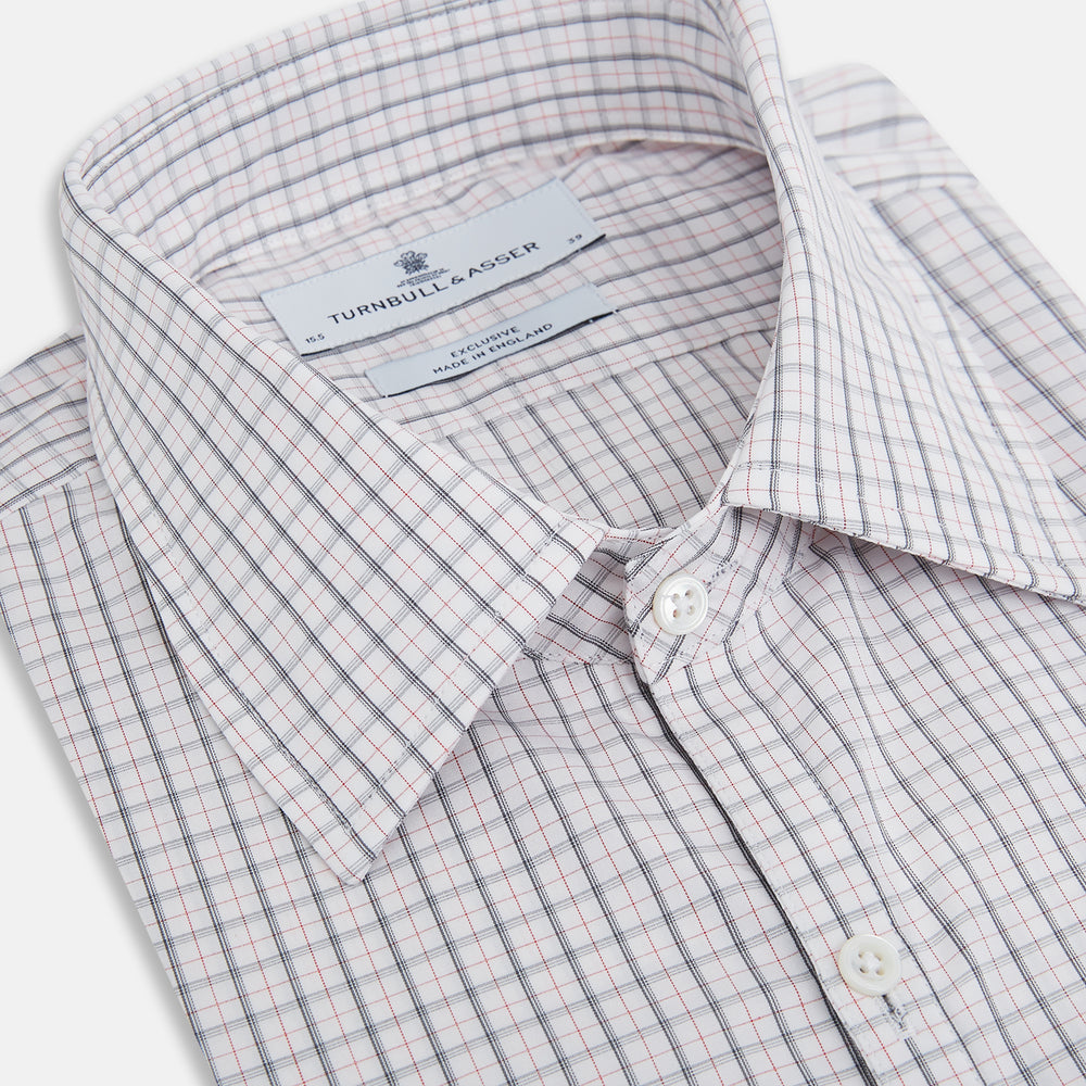 The Blue and Red Graph Check Westminster Shirt by Turnbull & Asser features a classic collar, long sleeves, and British craftsmanship, with a blue and red checkered pattern on white, displayed flat on a white surface.