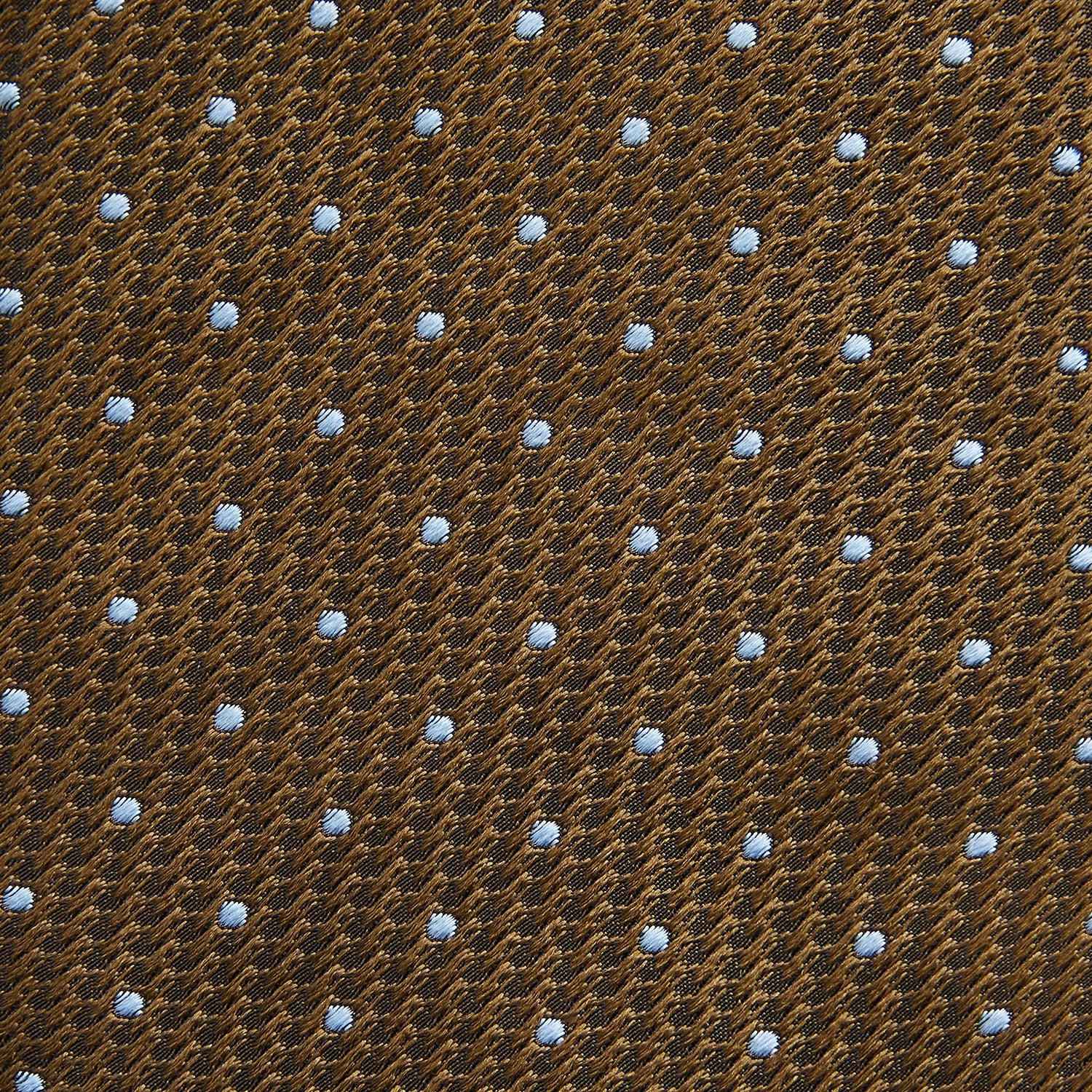 View 4 of product The LACE ON TONE SPOT EARTH RIVER TIE by Turnbull & Asser is a brown woven tie with small light blue dots, shown rolled up on a white background—a stylish accessory for formal outfits.