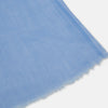View 2 of product The Azzurro Cashmere Scarf by Turnbull & Asser is shown in light blue, hand-dyed cashmere, semi-sheer and loosely knotted, displayed against a plain white background.