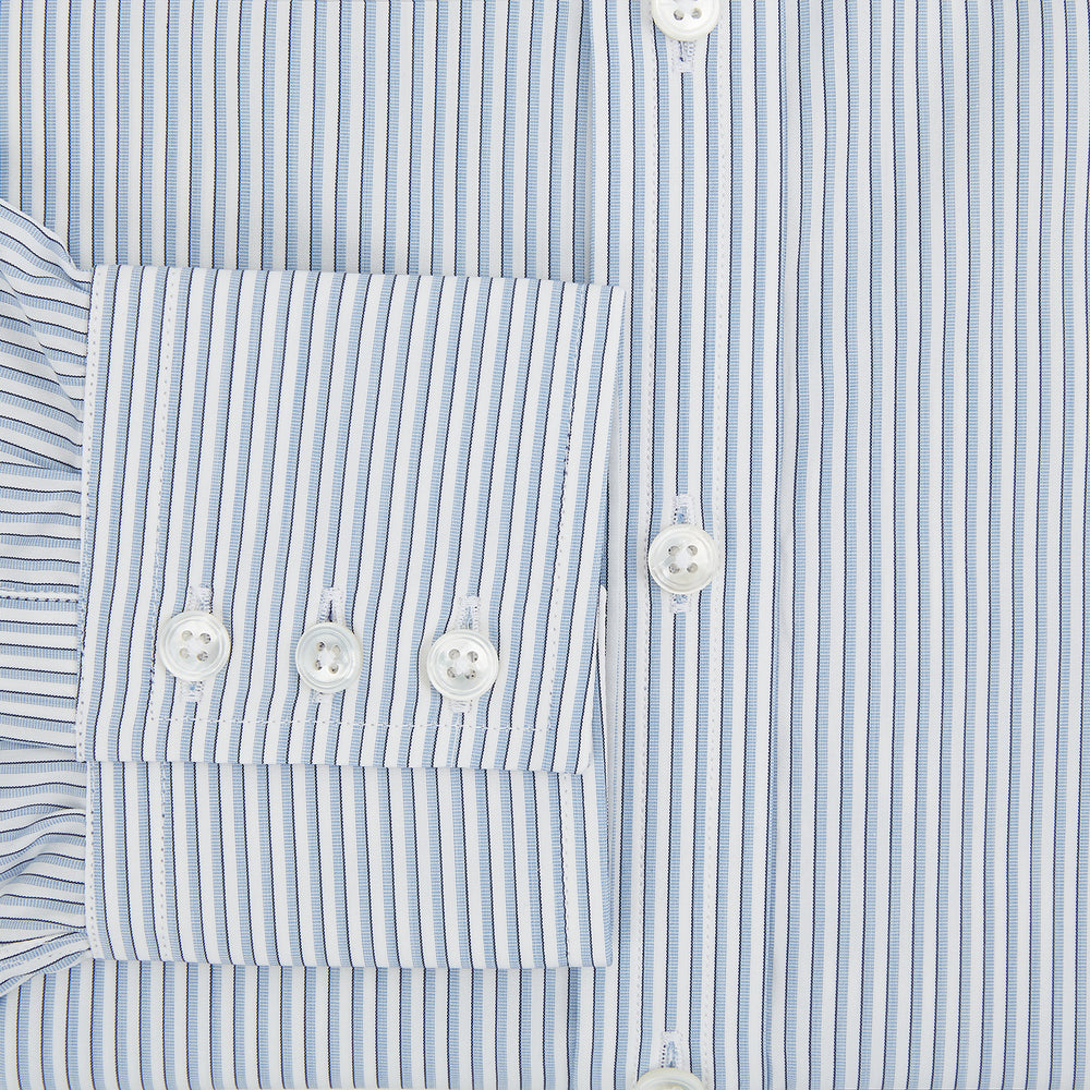 The Turnbull & Asser Sky Blue Shadow Pinstripe Mayfair Shirt, a long-sleeved, button-up shirt with a T&A collar and light blue and white thin vertical stripes, is displayed flat on a white background.
