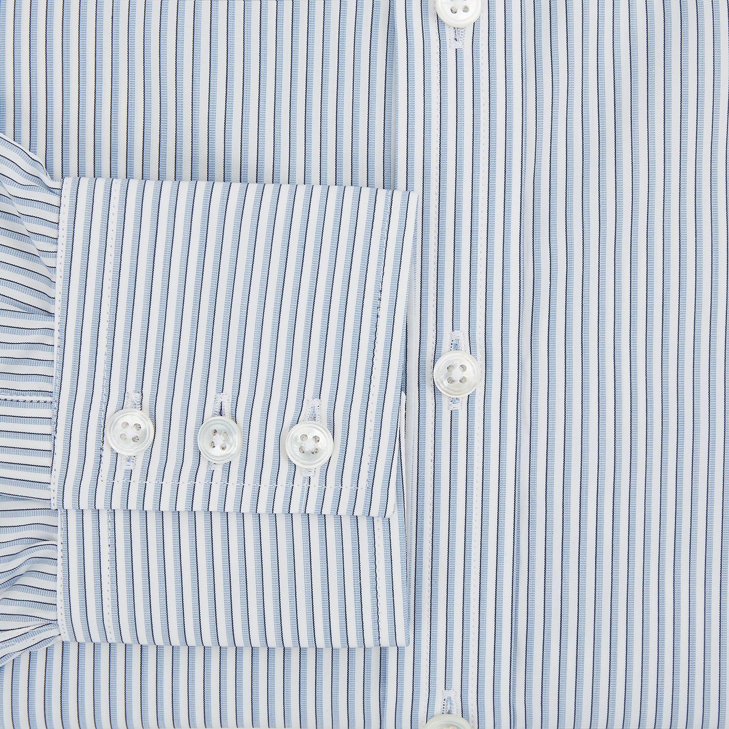 View 4 of product The Turnbull & Asser Sky Blue Shadow Pinstripe Mayfair Shirt, a long-sleeved, button-up shirt with a T&A collar and light blue and white thin vertical stripes, is displayed flat on a white background.