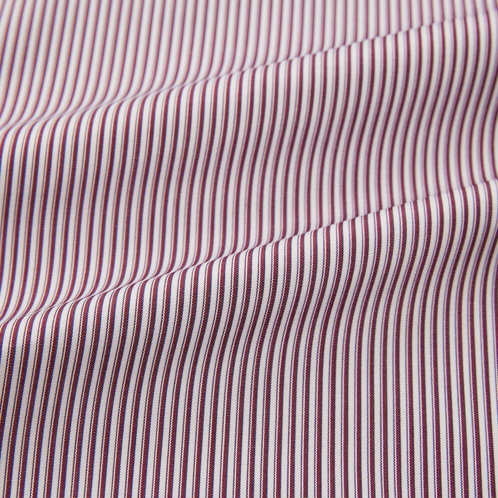 The Turnbull & Asser Burgundy Shadow Stripe Mayfair Shirt is a long-sleeved button-up with thin vertical burgundy stripes, classic collar, and buttoned cuffs, shown laid flat on a white background.