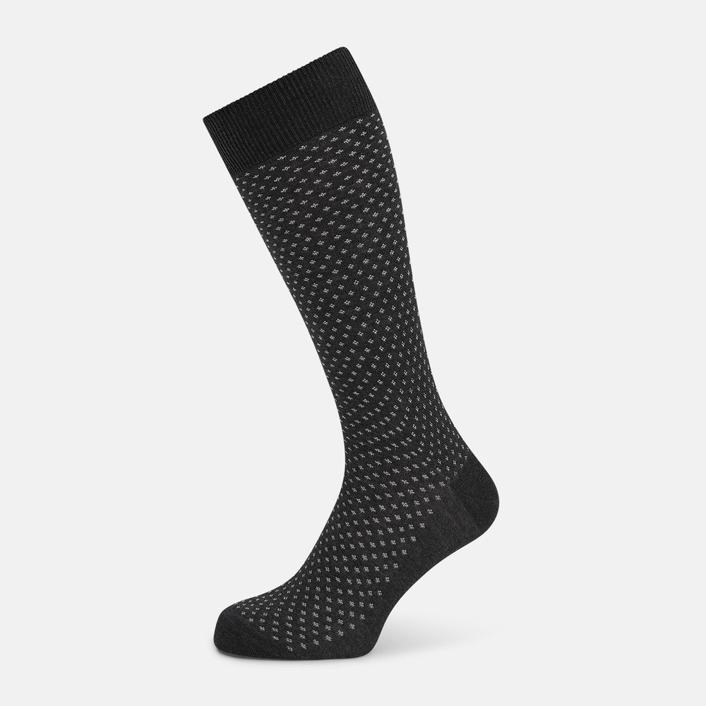 Turnbull & Asser Grey Motif Mid-Length Sock, crafted from Egyptian cotton, features a fine white geometric dot pattern on grey with a solid black cuff, heel, and toe for classic style. Displayed on a white background.