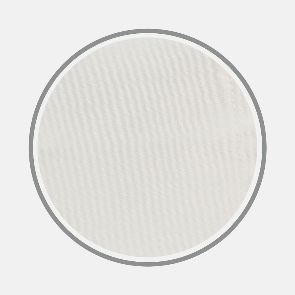 A close-up of Turnbull & Asser’s Cream Sea Island Quality Cotton Fabric is shown in a circular frame with a gray border, emphasizing its smooth texture and subtle stitching on the right side.