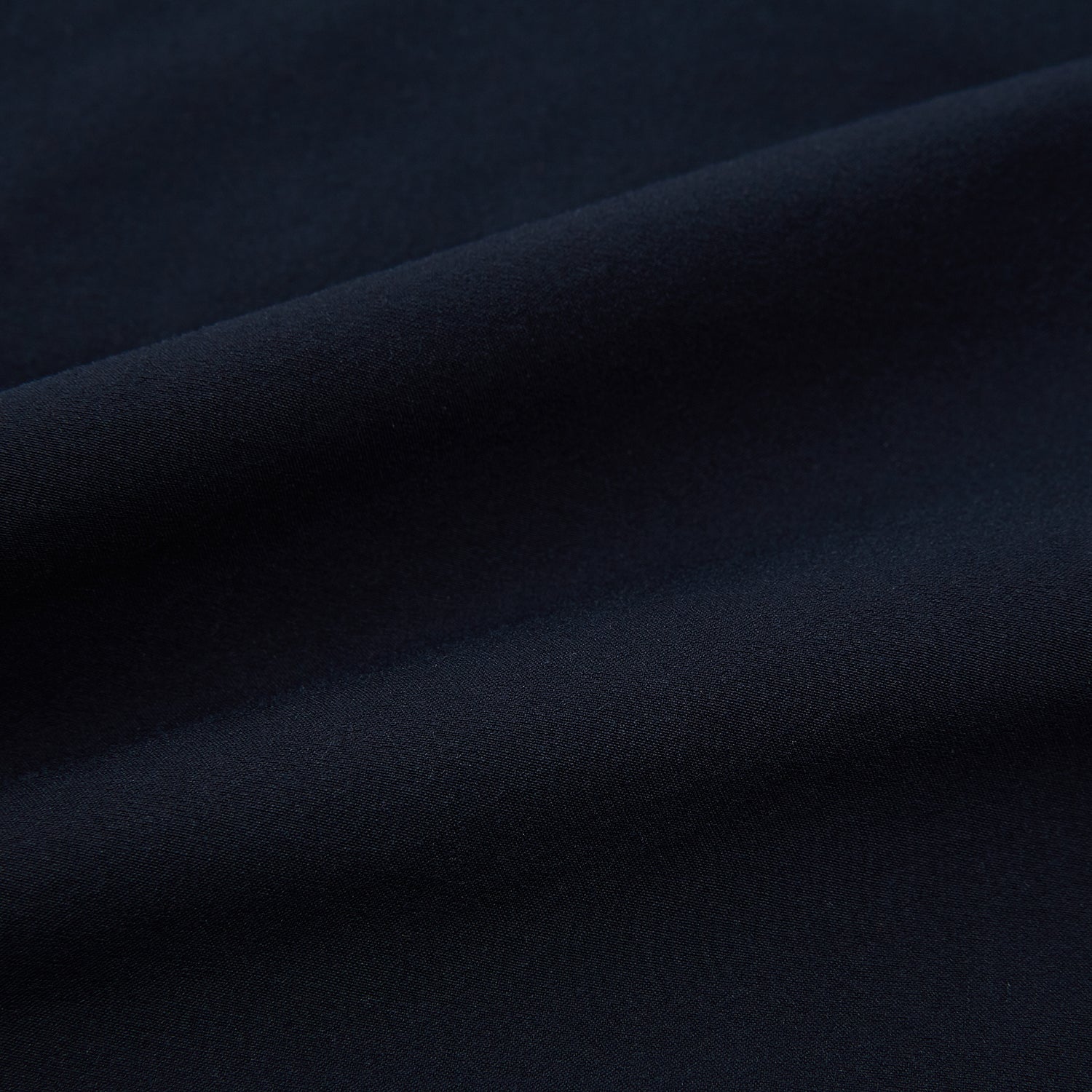 View 7 of product Turnbull & Asser’s Midnight Blue Winston Trousers, in high-twist cotton with belt loops and a button closure, are shown flat against a plain white background.