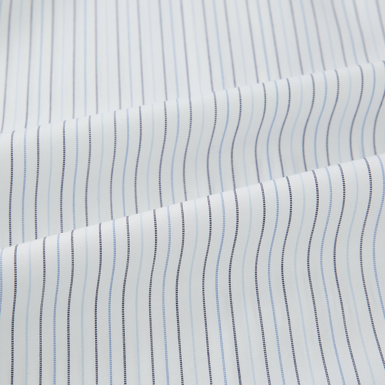 View 6 of product The Turnbull & Asser Blue Multi-Tone Double Pinstripe Mayfair Shirt, crafted from premium Italian cotton with a pointed collar, buttoned cuffs, and long sleeves, is shown on a plain white background.