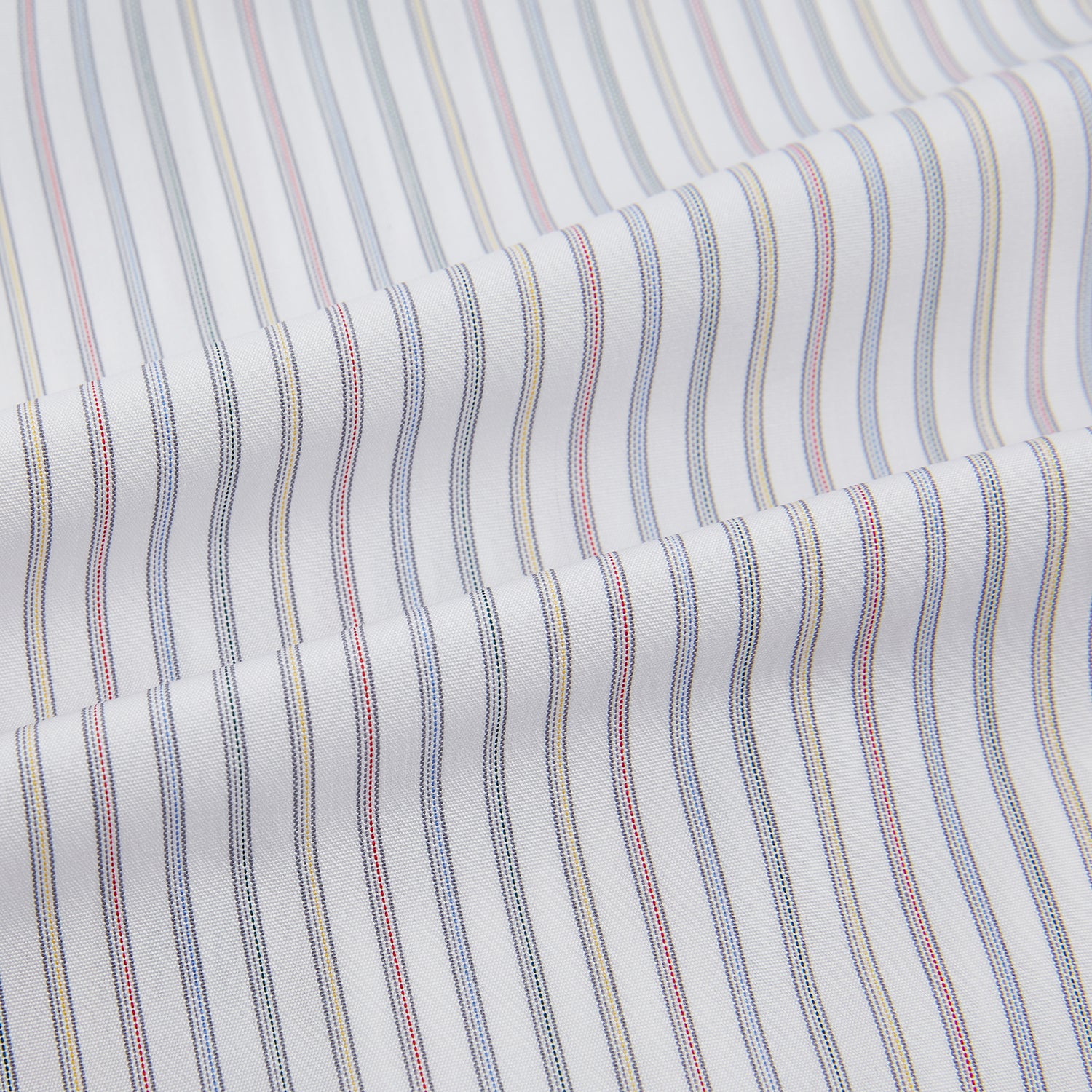 View 6 of product The Turnbull & Asser Multicoloured Music Stripe Mayfair Shirt features thin blue and white vertical stripes, a classic T&A collar, and buttoned cuffs, shown laid flat on a white background.