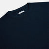 View 2 of product The Turnbull & Asser Navy Cashmere Round Neck Jumper for men is shown against a white background, featuring long sleeves, a relaxed fit, and ribbed cuffs, hem, and collar for an effortlessly elegant look.