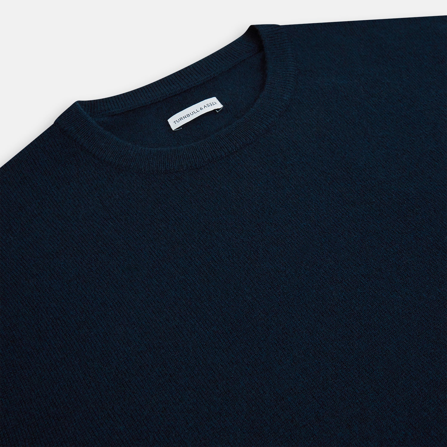 View 2 of product The Turnbull & Asser Navy Cashmere Round Neck Jumper for men is shown against a white background, featuring long sleeves, a relaxed fit, and ribbed cuffs, hem, and collar for an effortlessly elegant look.