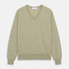 View 1 of product A light green Kennedy Merino V-neck jumper by Turnbull & Asser is laid flat on a white background. This knitwear piece features ribbed cuffs and hem, offering a simple, classic design ideal for any wardrobe.