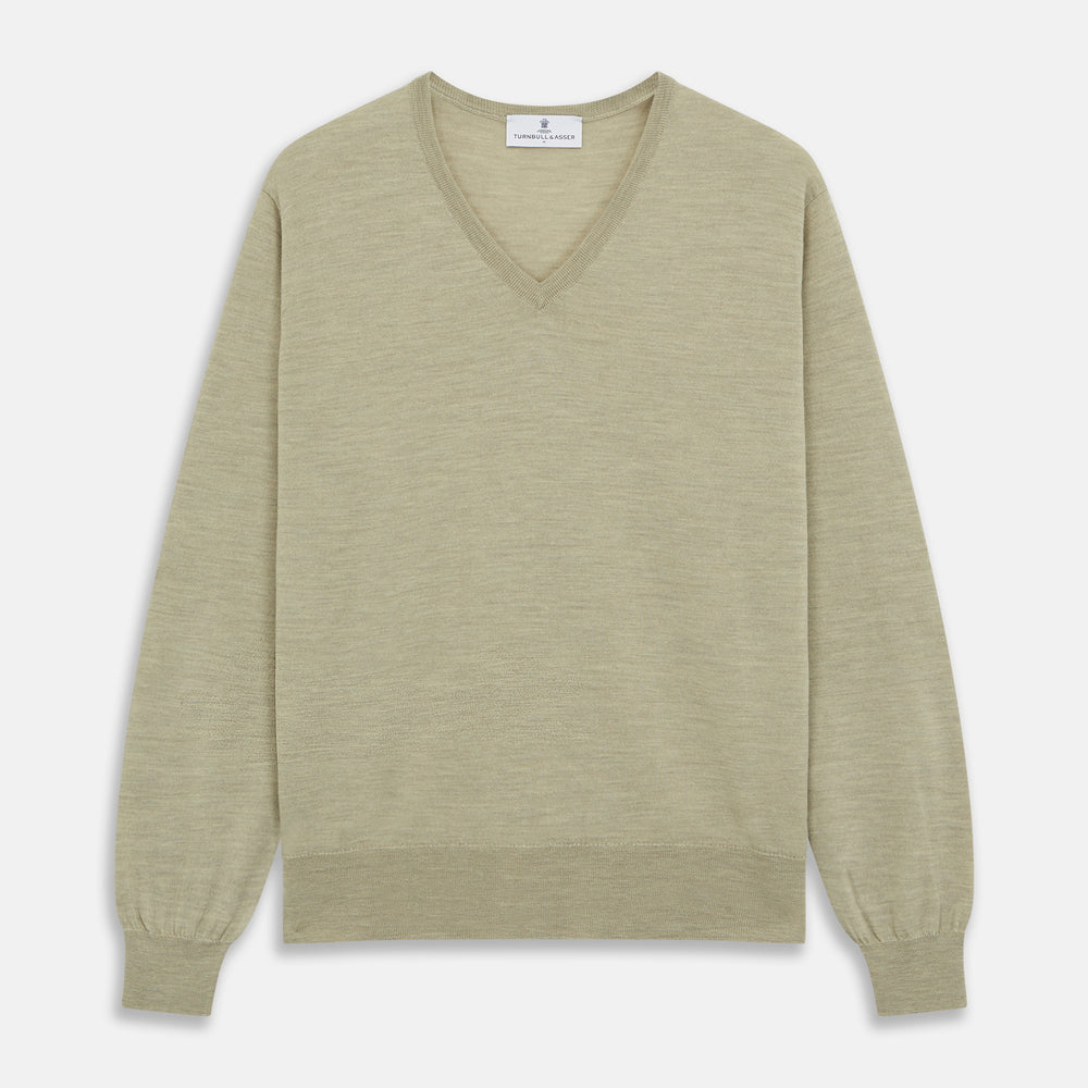 A light green Kennedy Merino V-neck jumper by Turnbull & Asser is laid flat on a white background. This knitwear piece features ribbed cuffs and hem, offering a simple, classic design ideal for any wardrobe.